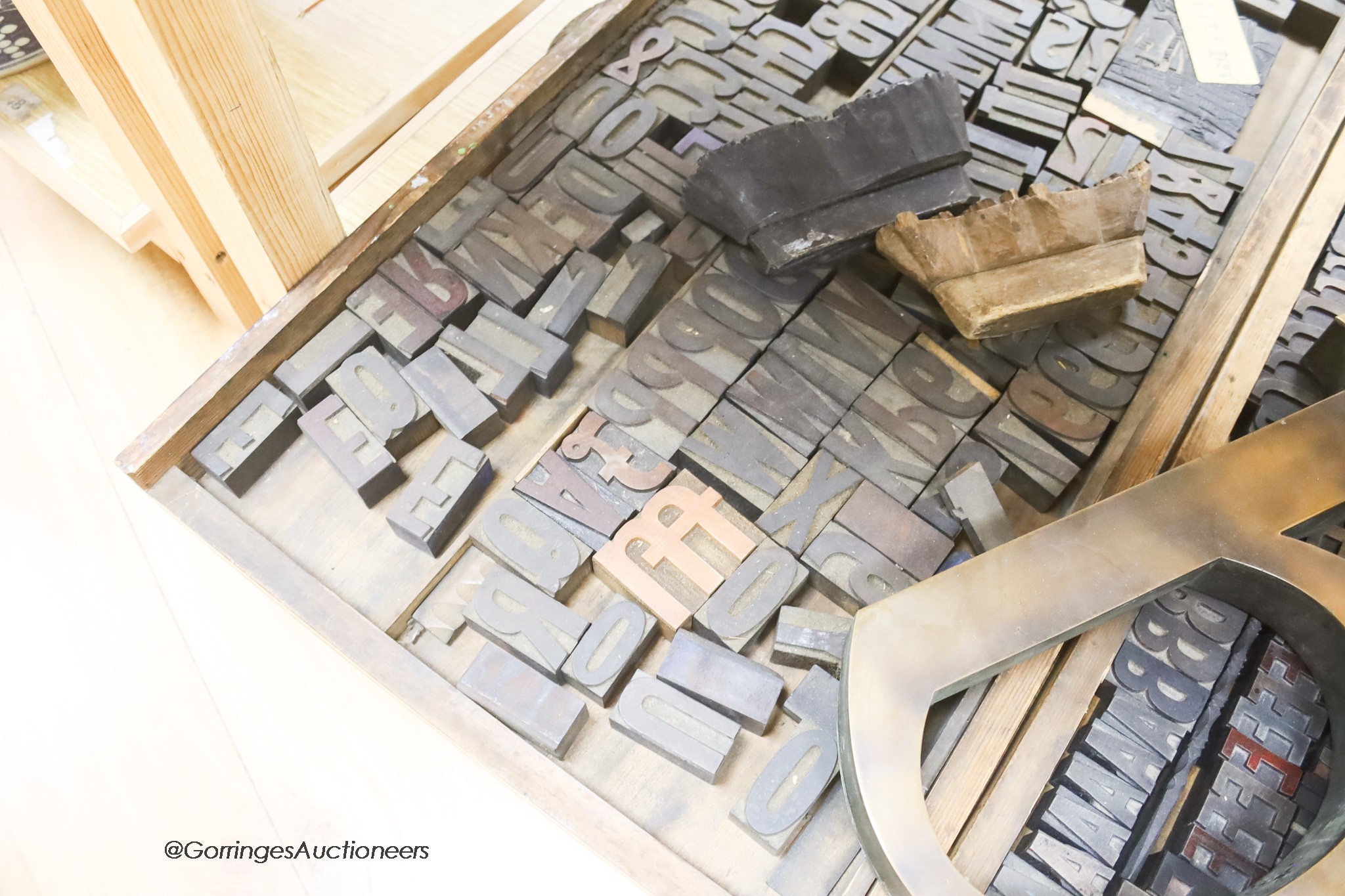 Three trays of printing blocks and letters two other patterned printing blocks and a large brass model of the letter b